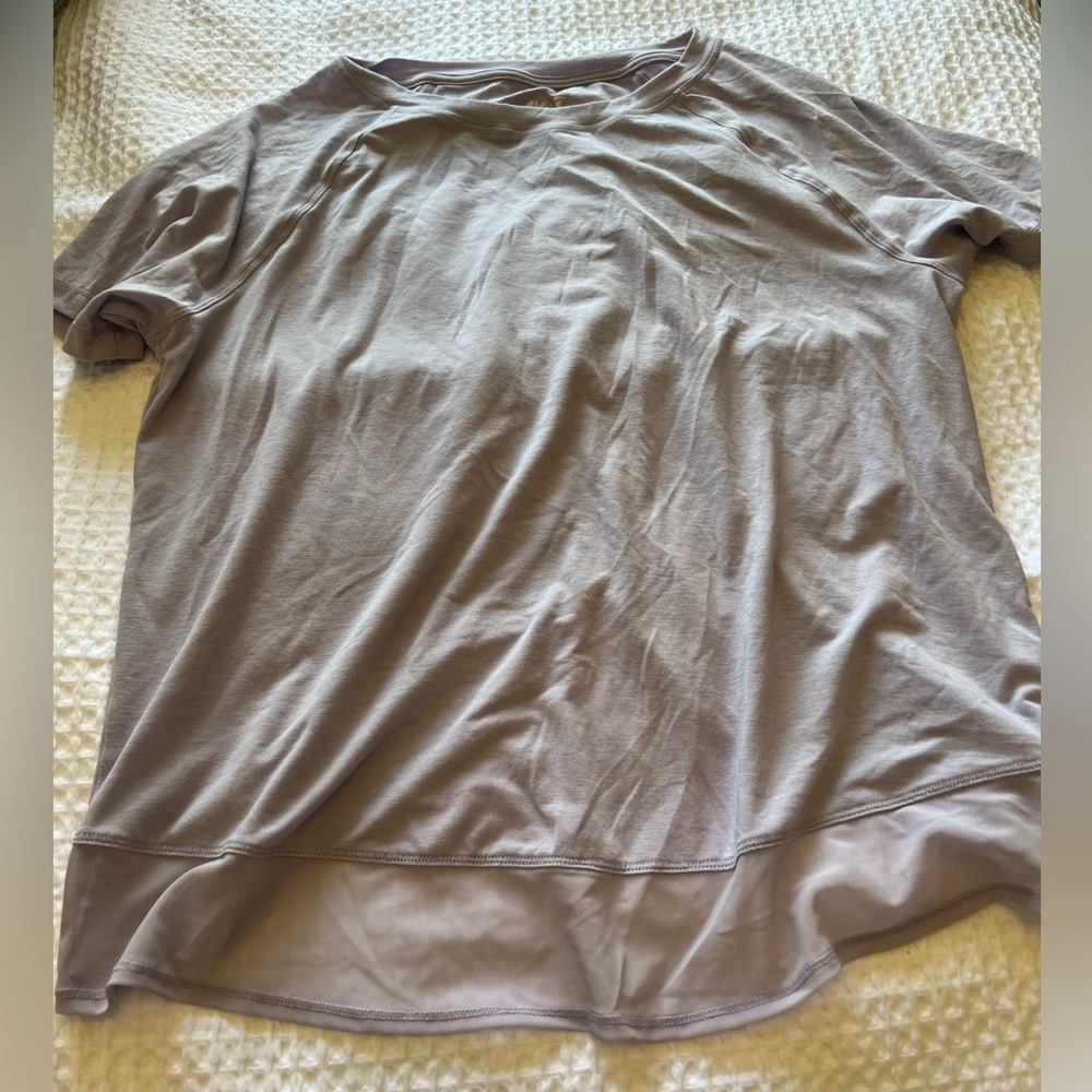 Lavender T-shirt with crisscross detail on the back and mesh